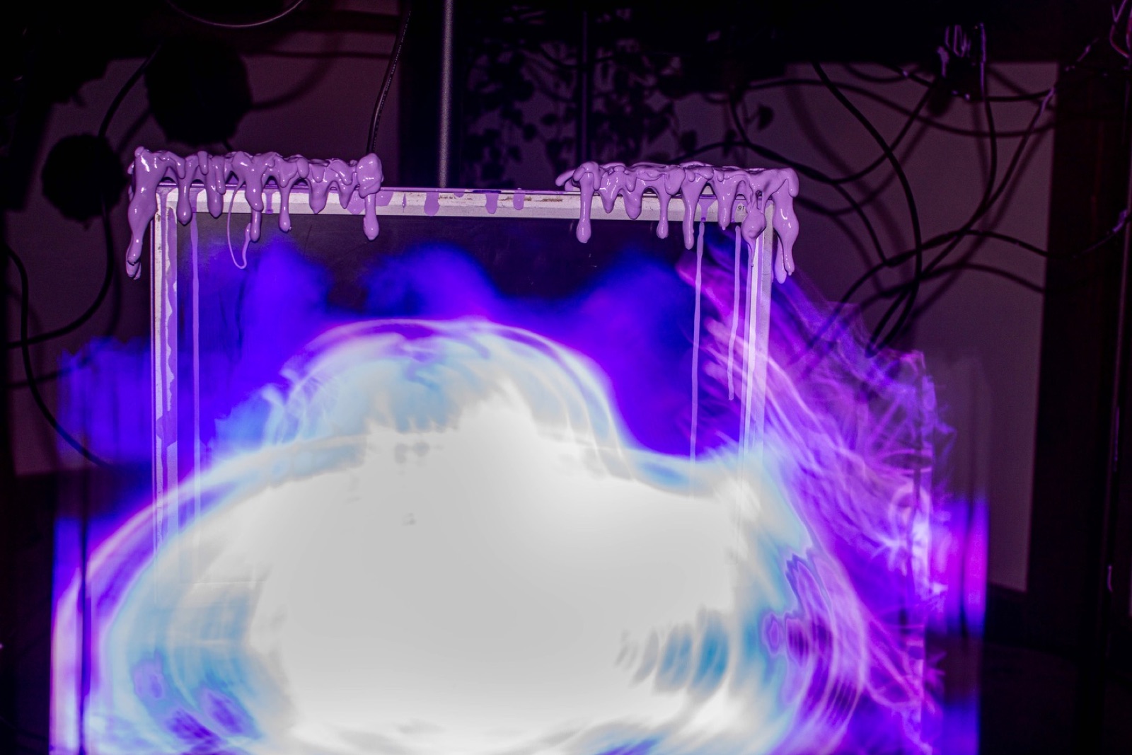pale lilac cyberslime dripping over the top edge of a monitor, the screen beneath showing a white and blue swirl like smoke caught underwater.